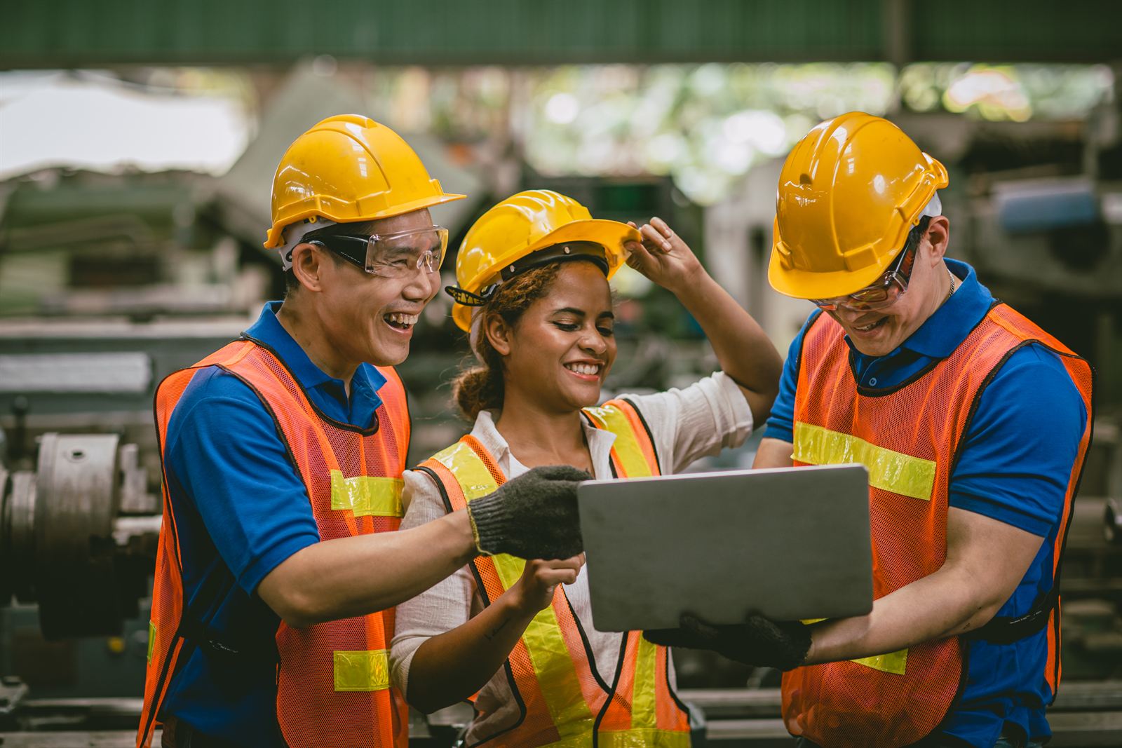 Malaysian factory team reviewing inspection checklist software on a laptop. Nexus ICMMS digital checklist platform for multi-site facility operations and field workforce audits